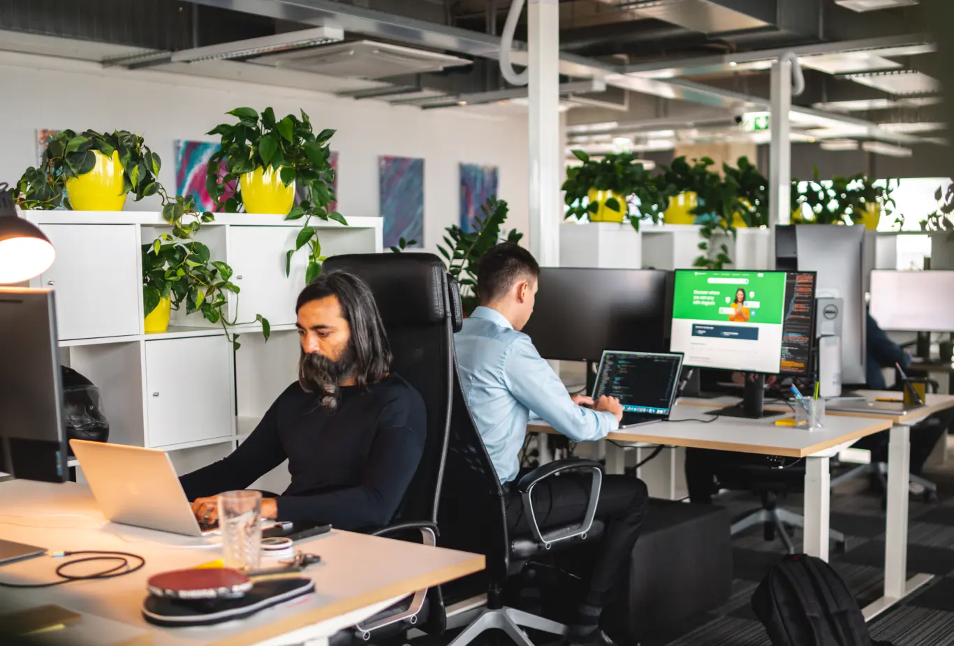 NuWare team members working together in the office
